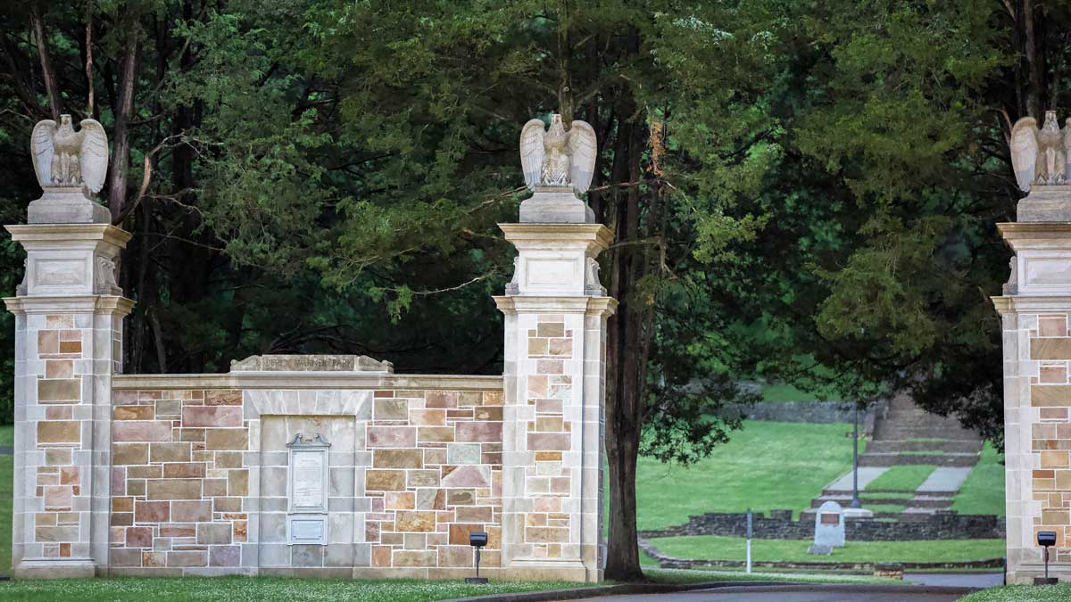 Percy Warner Park stone gates at the Belle Meade entrance in Nashville, Tennessee, surrounded by mature trees.