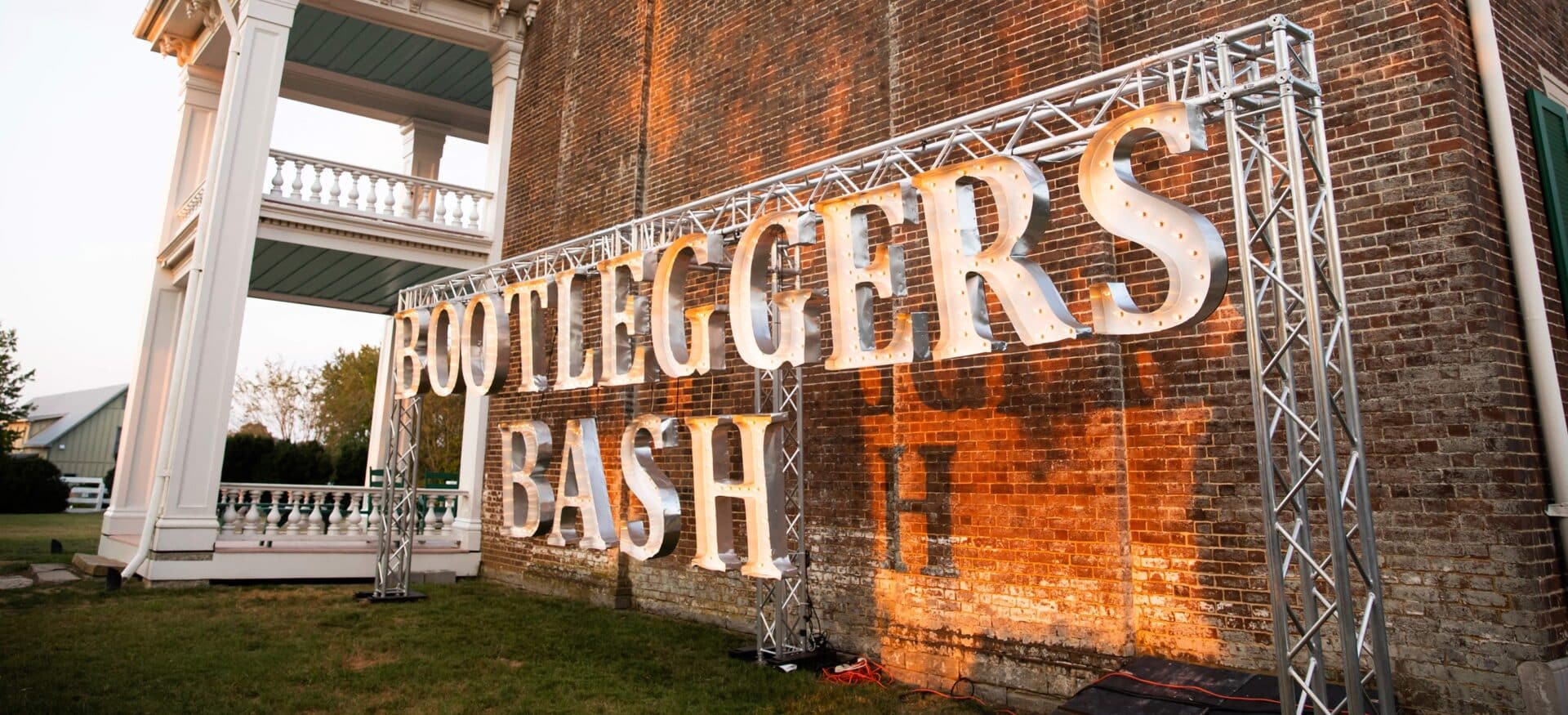 Bootlegger’s Bash sign, an annual event in Franklin, TN featuring Tennessee distillers, a traditional Southern dinner and live entertainment featuring Rock & Roll Pianos – a dueling piano team.