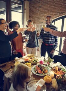 People standing, cheering before eating at a Franklin, TN restaurant serving Thanksgiving dinner.