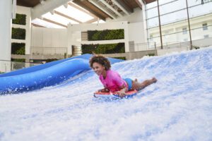 Kids activities at SoundWaves in Nashville TN, an 84-degree indoor oasis of 110,000 square-feet that allows guests to soak in the sun during the winter, surf on Nashville’s only FlowRider®, take a plunge off of a suspenseful waterslide, zip through the currents of a rpid river and more, additionally, the water attraction features an arcade with virtual relaity games, a rock climbing wall, game tables and more.