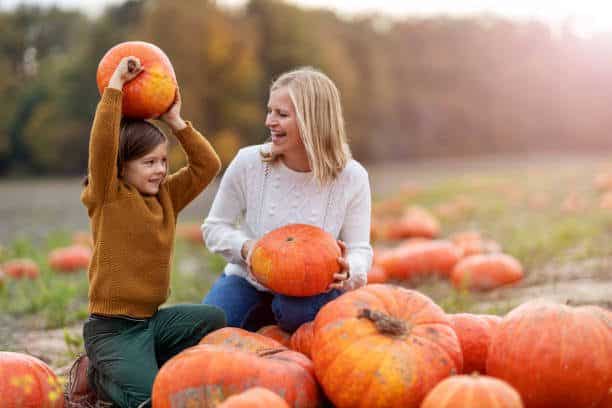 5 Festive Halloween Events in Franklin! - Mother and son in a pumpkin patch field.