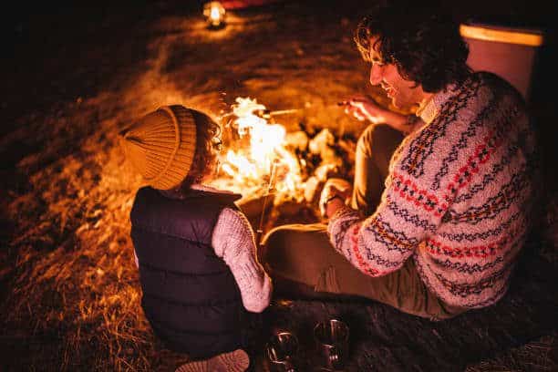 Things to do this week in Franklin & Williamson County, a father and son having fun sitting around campfire and roasting marshmallows.