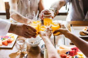 Group enjoying brunch in Brentwood, TN, restaurant table with brunch foods and and orange juice toast!