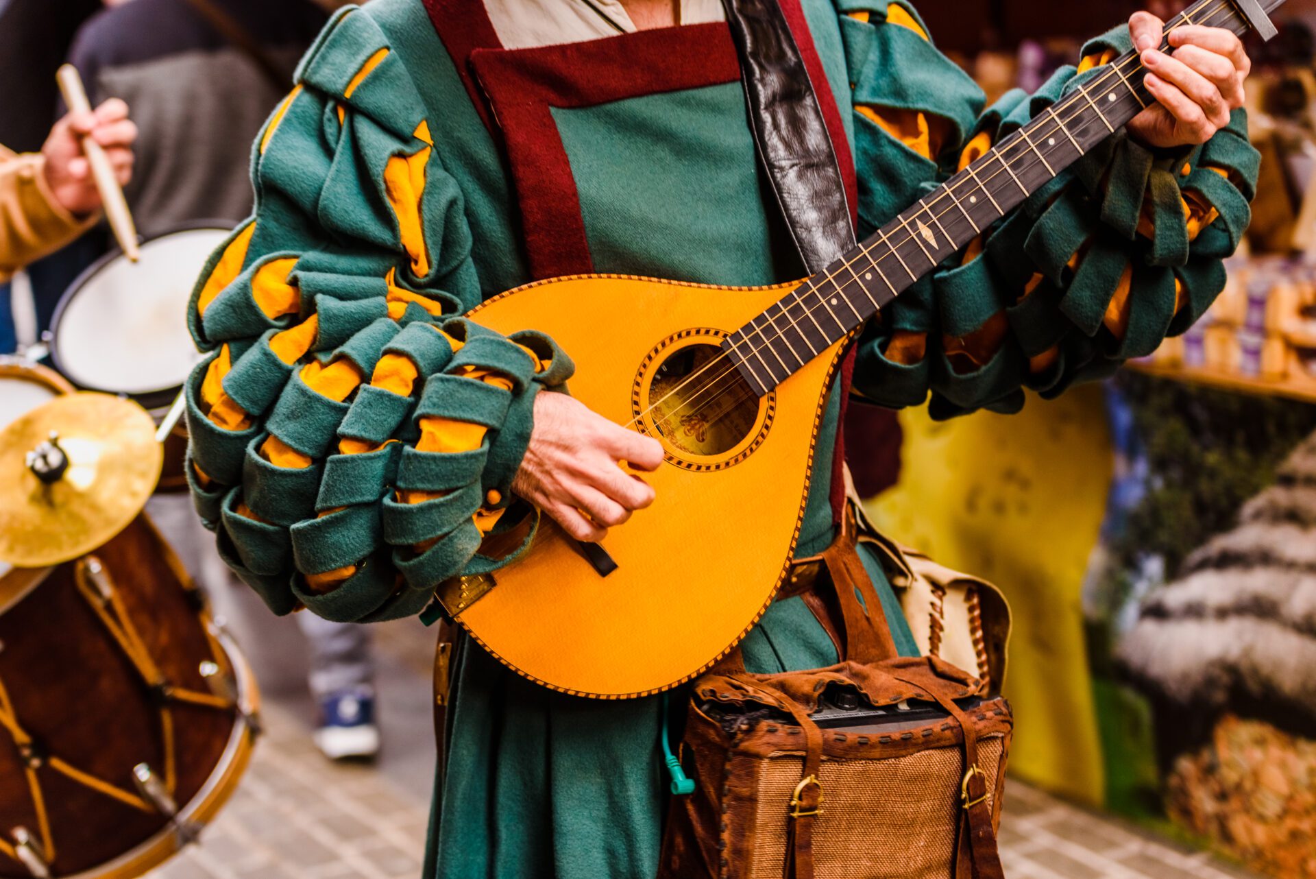 Tennessee Renaissance Festival, medieval troubadour playing an antique guitar.