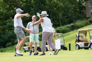 GraceWorks CEO Valencia A. Breckenridge is congratulated by other golfers at the organization’s annual Golf Fore GraceWorks Challenge.