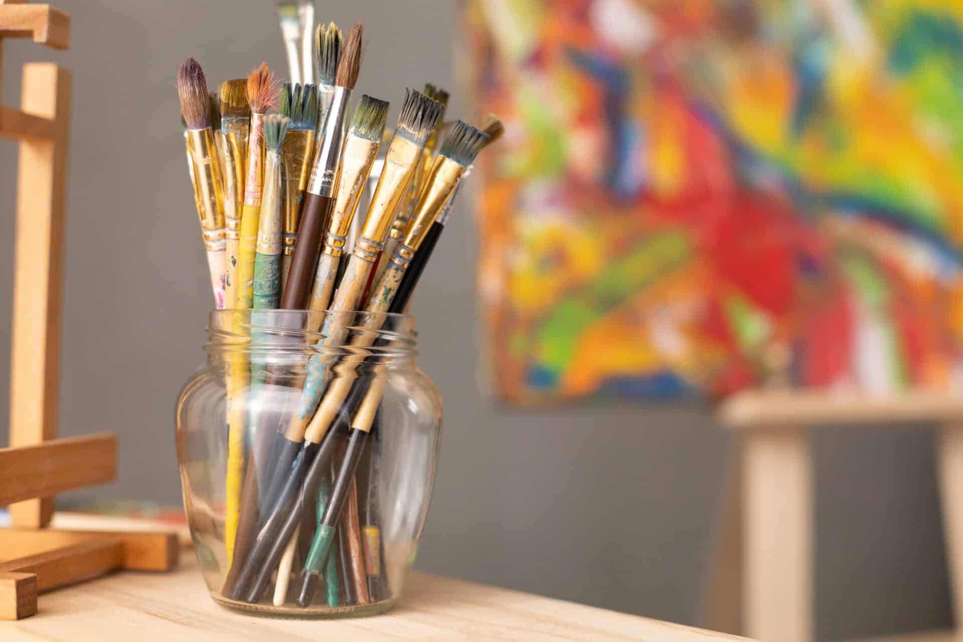 Paintbrushes in a jar, article features a list of art studios and art galleries in Franklin and Williamson County, Tennessee.