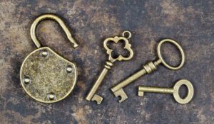 Escape room games in Franklin, Tennessee, antique keys and padlock on a rusty metal background