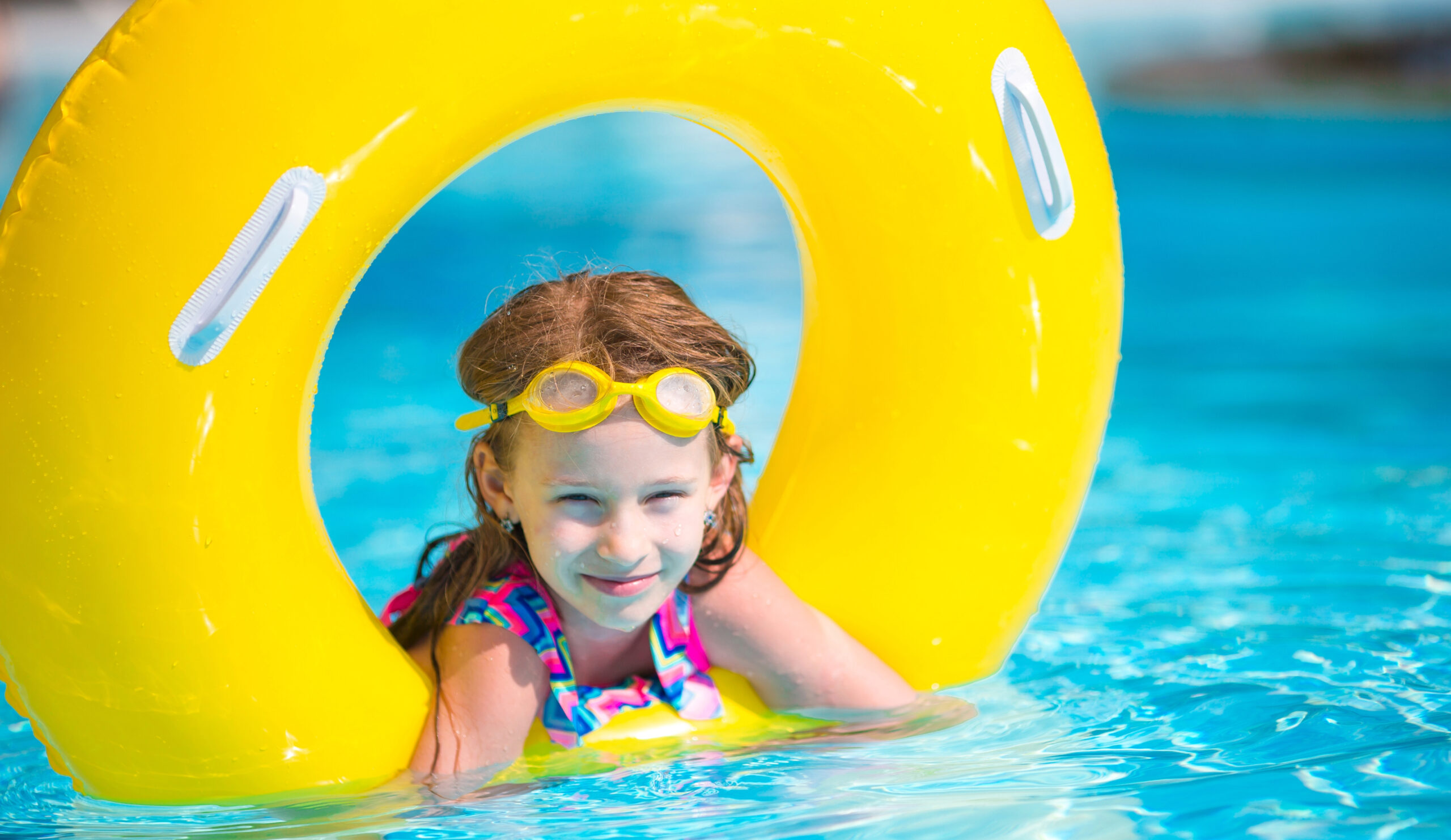 Girl in pool with yellow float