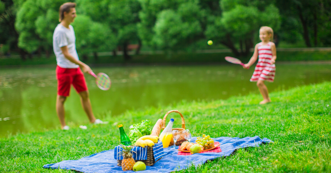 Family playing Badminton while on a picnic in Franklin, Tennessee.