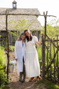 Brooke Giannetti and Dauther Leila at the gate to The Bloomerie . The Shed in the background. Photo by Lisa Romerein.