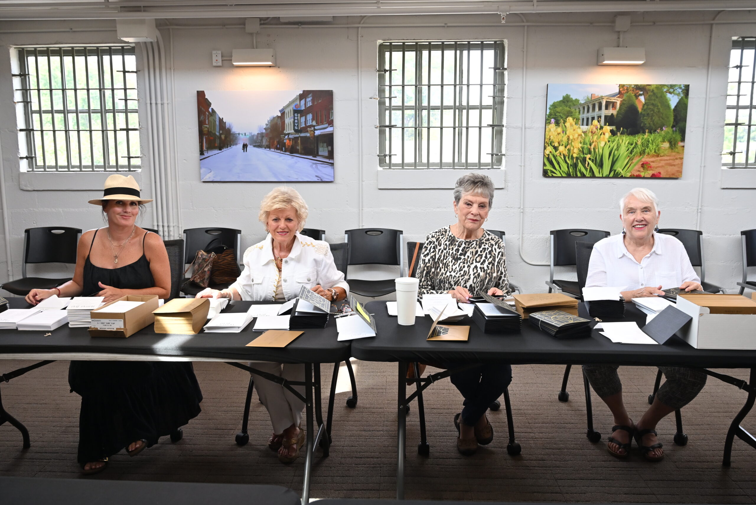 Michelle Glass, Judy Jackson, Kay Awalt Musgrove and Dawn Dellos stuffing invitations for the Heritage Ball.