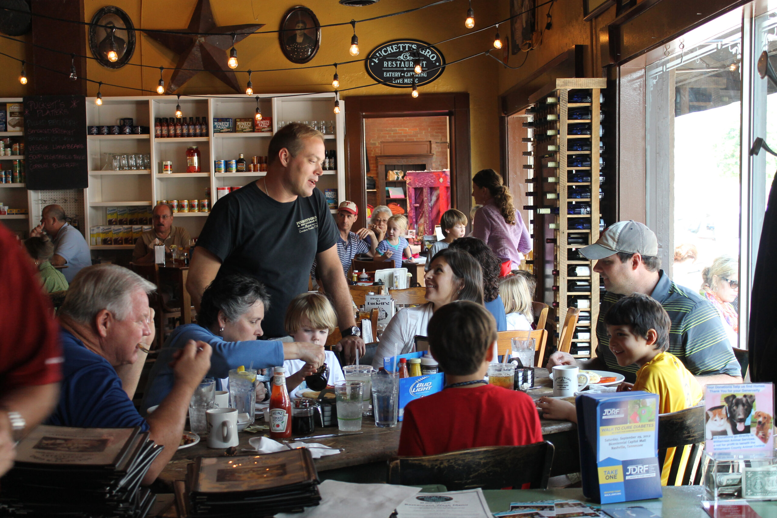 Puckett’s Restaurant Downtown Franklin, TN- Server at Table with Family.