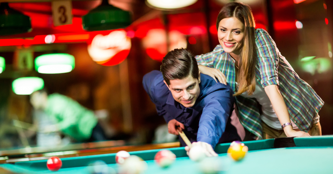 Couple playing pool at Kings Bowl in Franklin on date night.