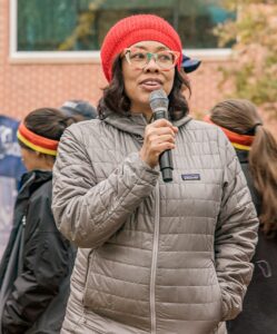 Niya Moon, Jackson Manager of Corporate Philanthropy, cheers on Turkey Trot runners at the start line.