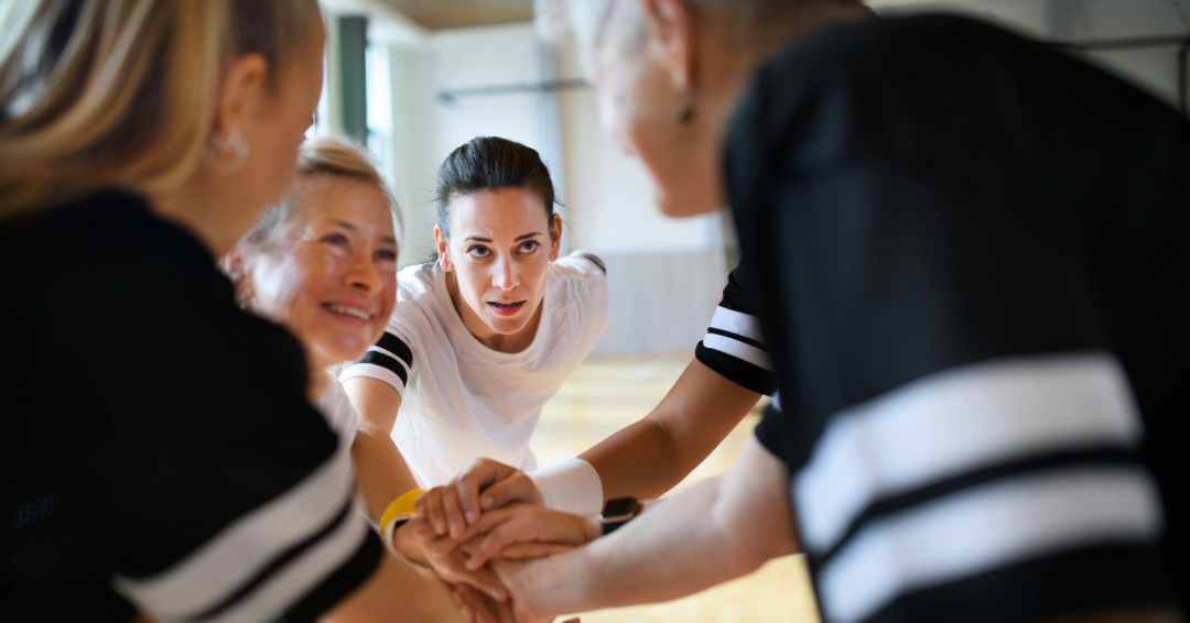 Adult sports leagues in Franklin and Williamson County, TN, women gathered in a sports huddle.