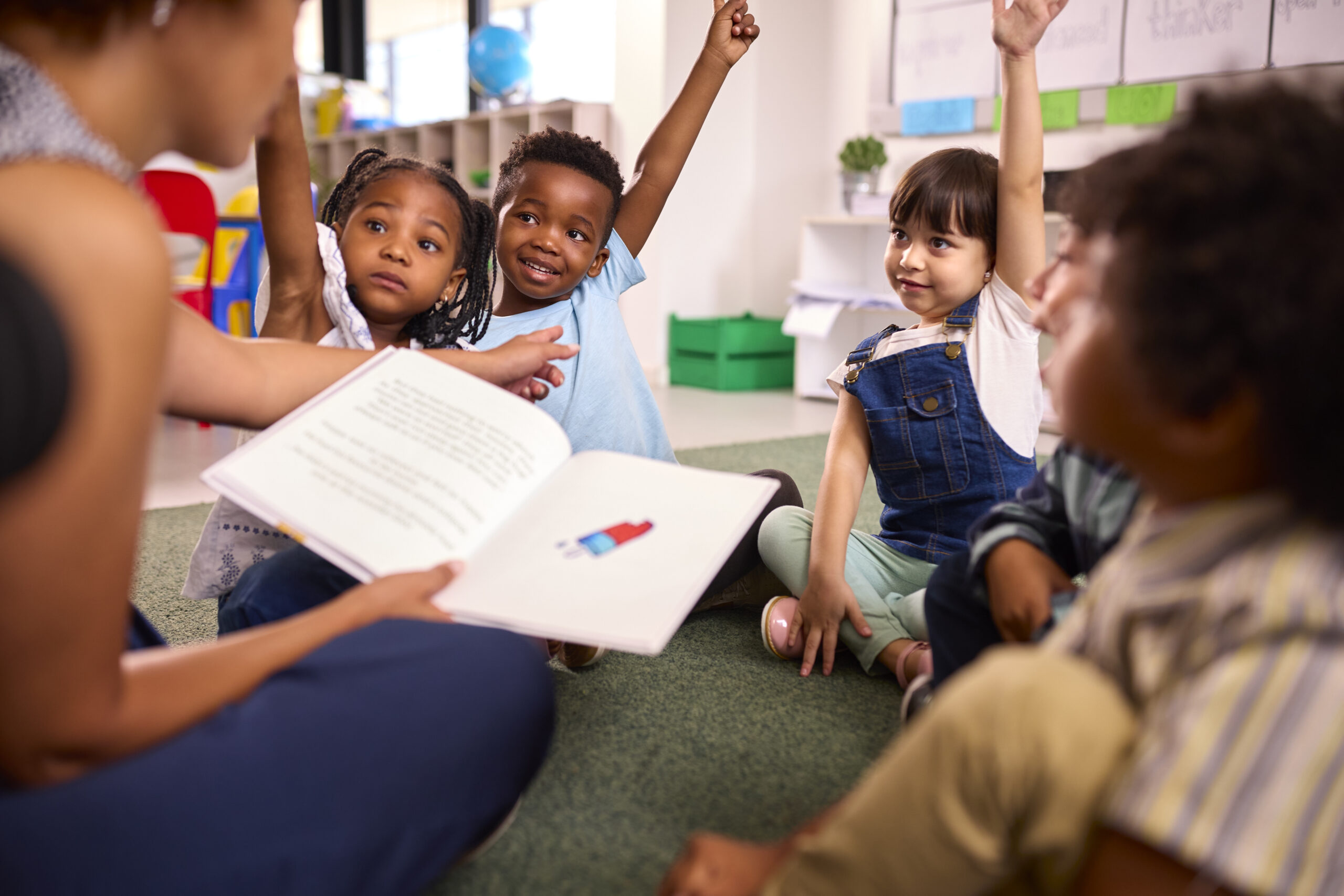 Open book, classroom, students raising hands, volunteer to tutor in Williamson County, TN, today!