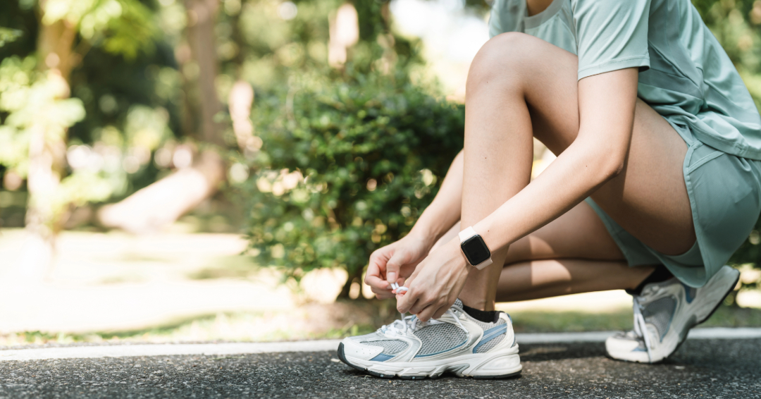 A woman tying on tennis shoes before a run, find running gear in Franklin, TN.