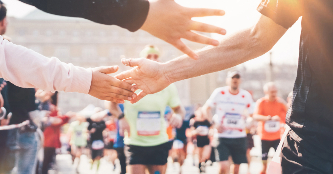 Runners high-fiving at a race, find local races and running events in Franklin, TN on FranklinIs.