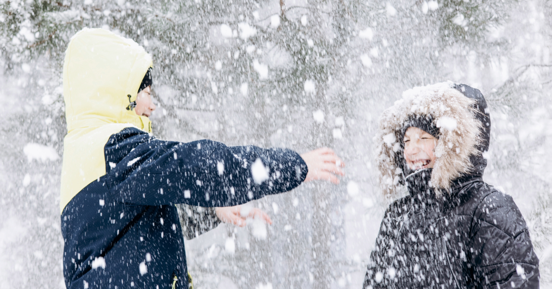 Two boys in coats playing in the snow, school day closures in Williamson County, Tennessee. 