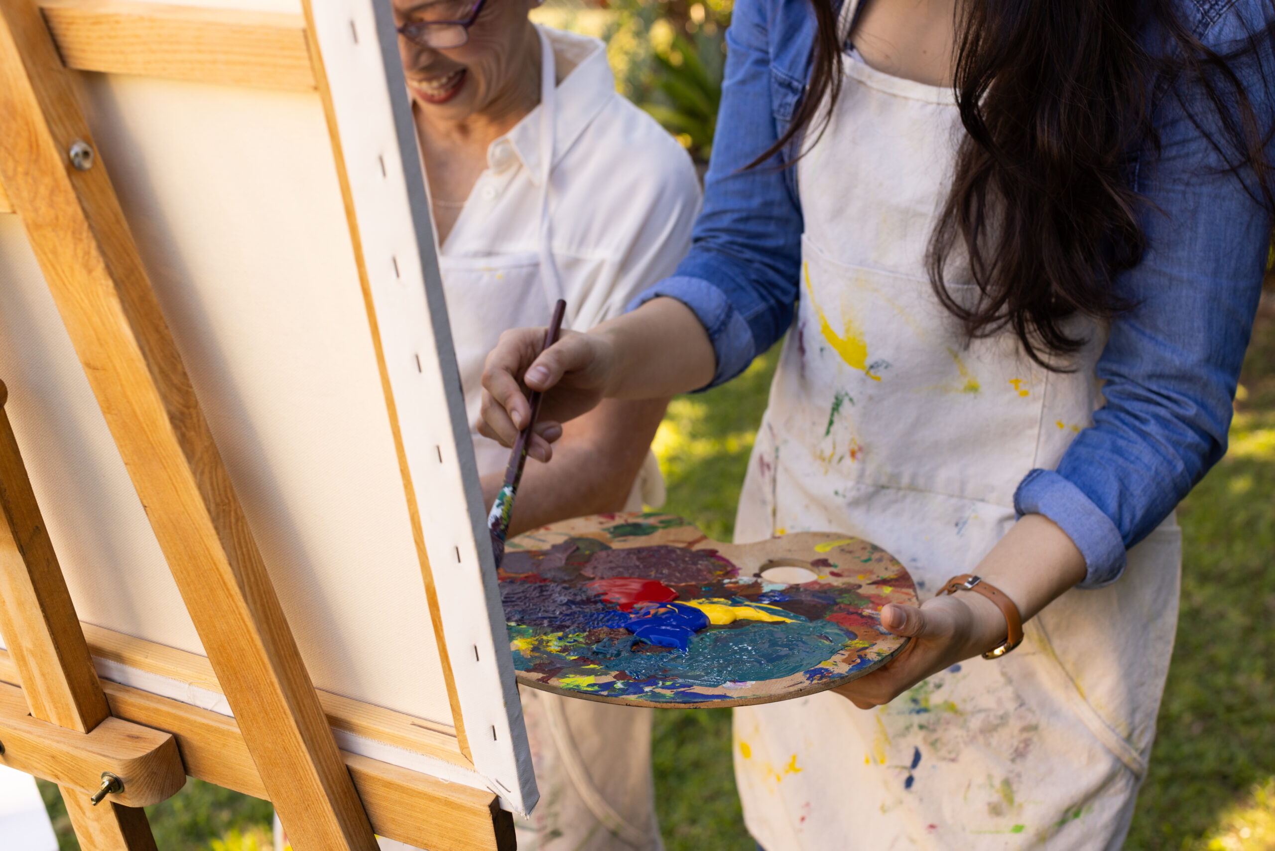 Artists painting with colorful paint on canvas in Franklin, TN.