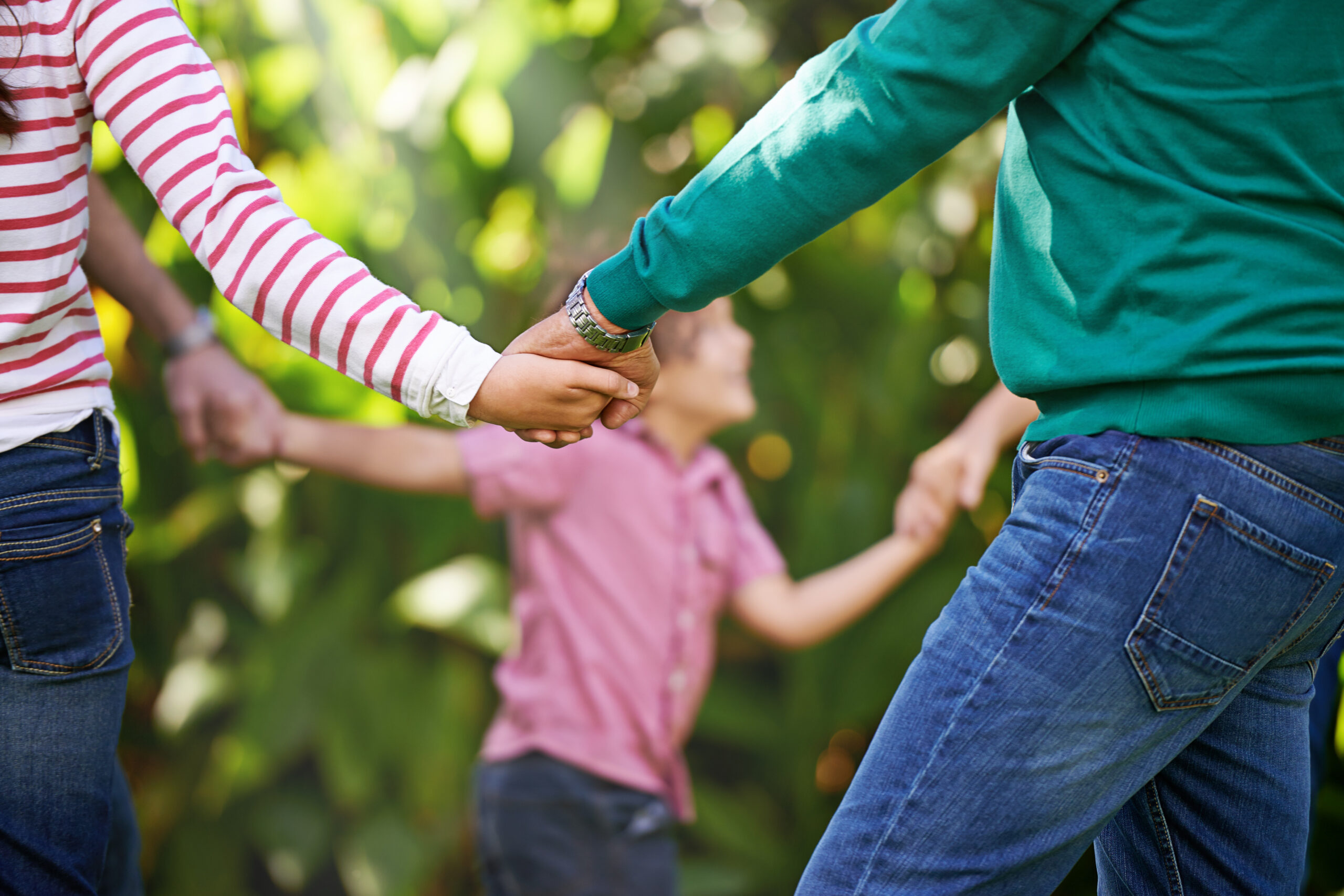 A family holding hands in a circle.