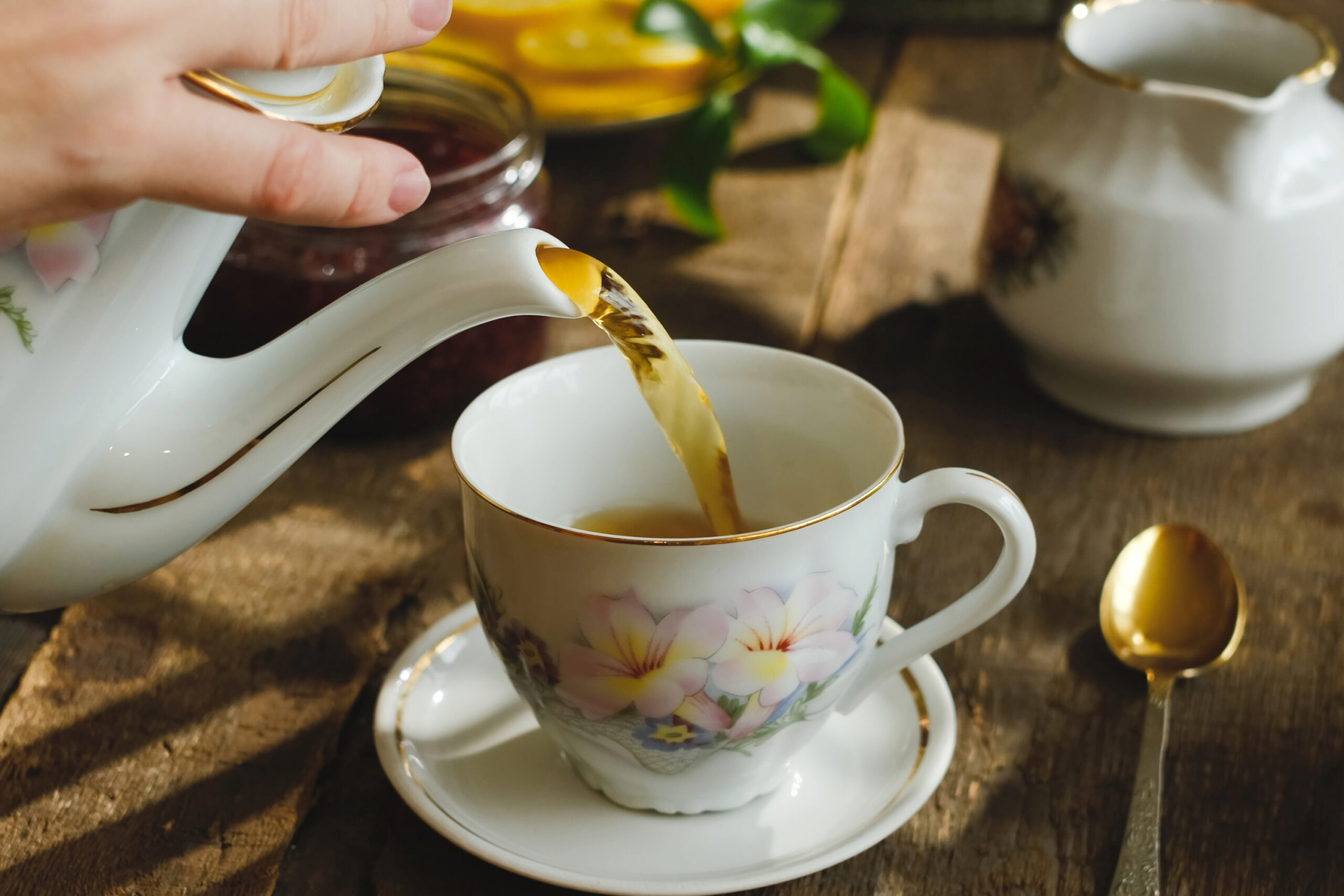 Tea room in Franklin, Tennessee, pouring tea into a flowery tea cup for afternoon tea.