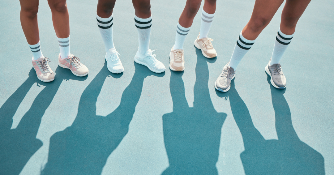 Four women wearing pastel tennis shoes.