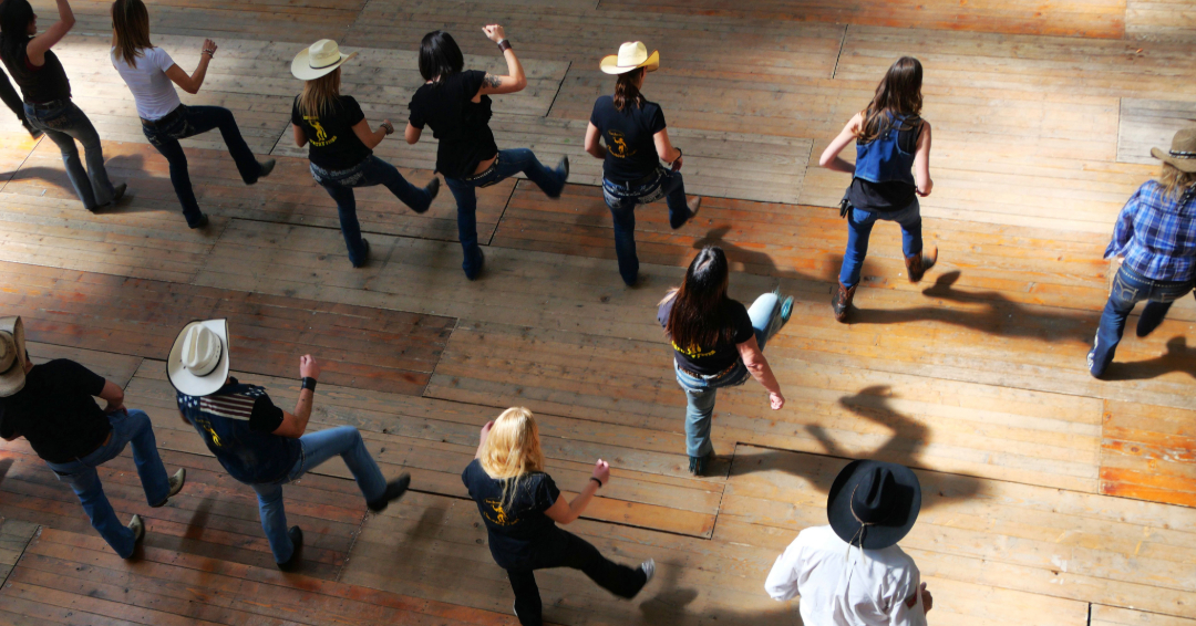 Bird-eye view of people line dancing.