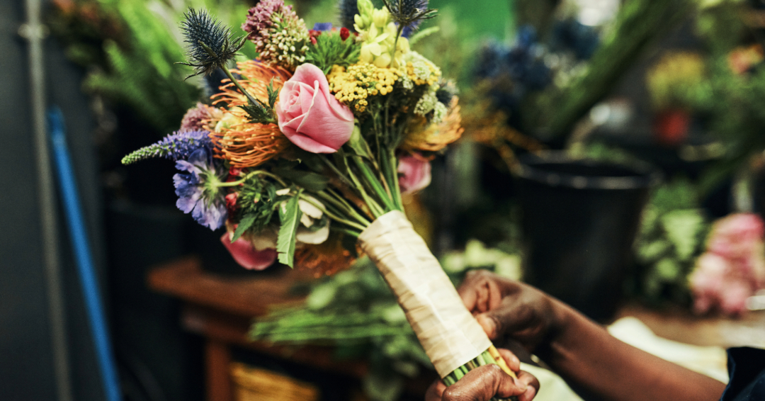 A woman holding a pretty, colorful bouquet. 