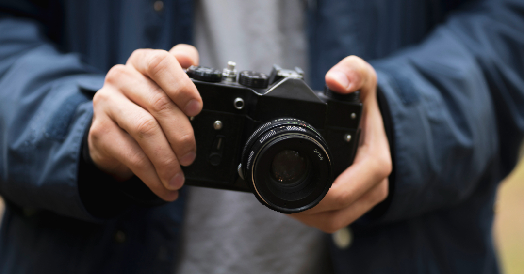 A man with a camera in his hands. 