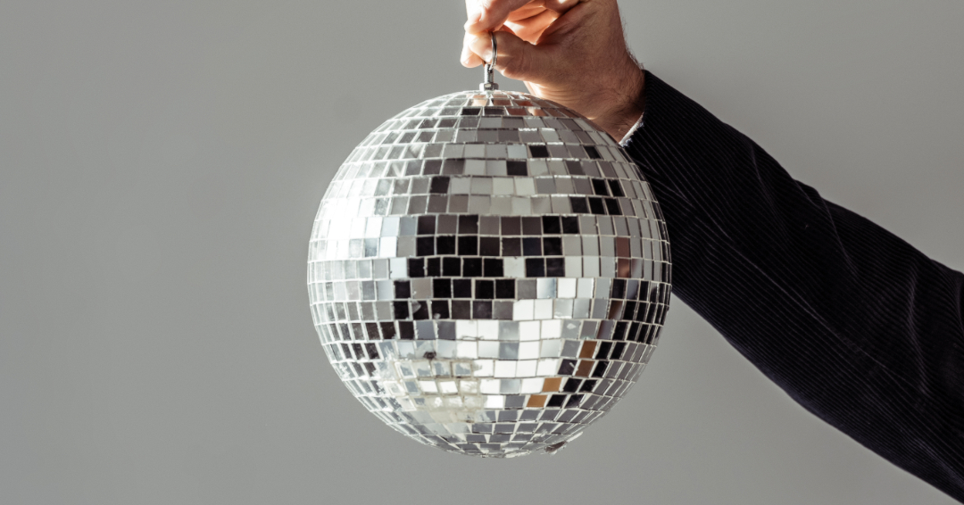 Person holding disco ball up. 