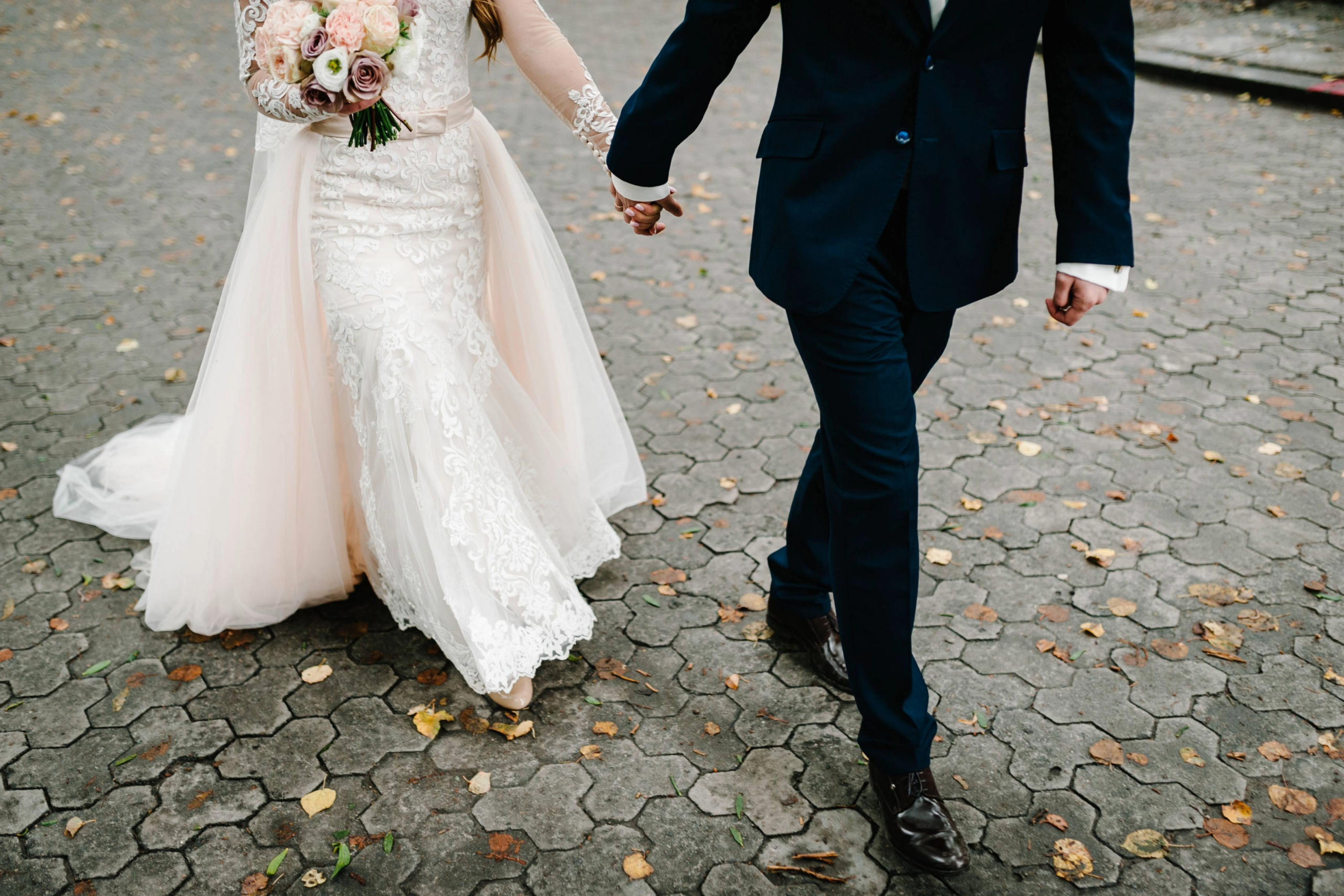 Wedding planning in Williamson County, Tennessee: a bride and groom walking, holding hands.