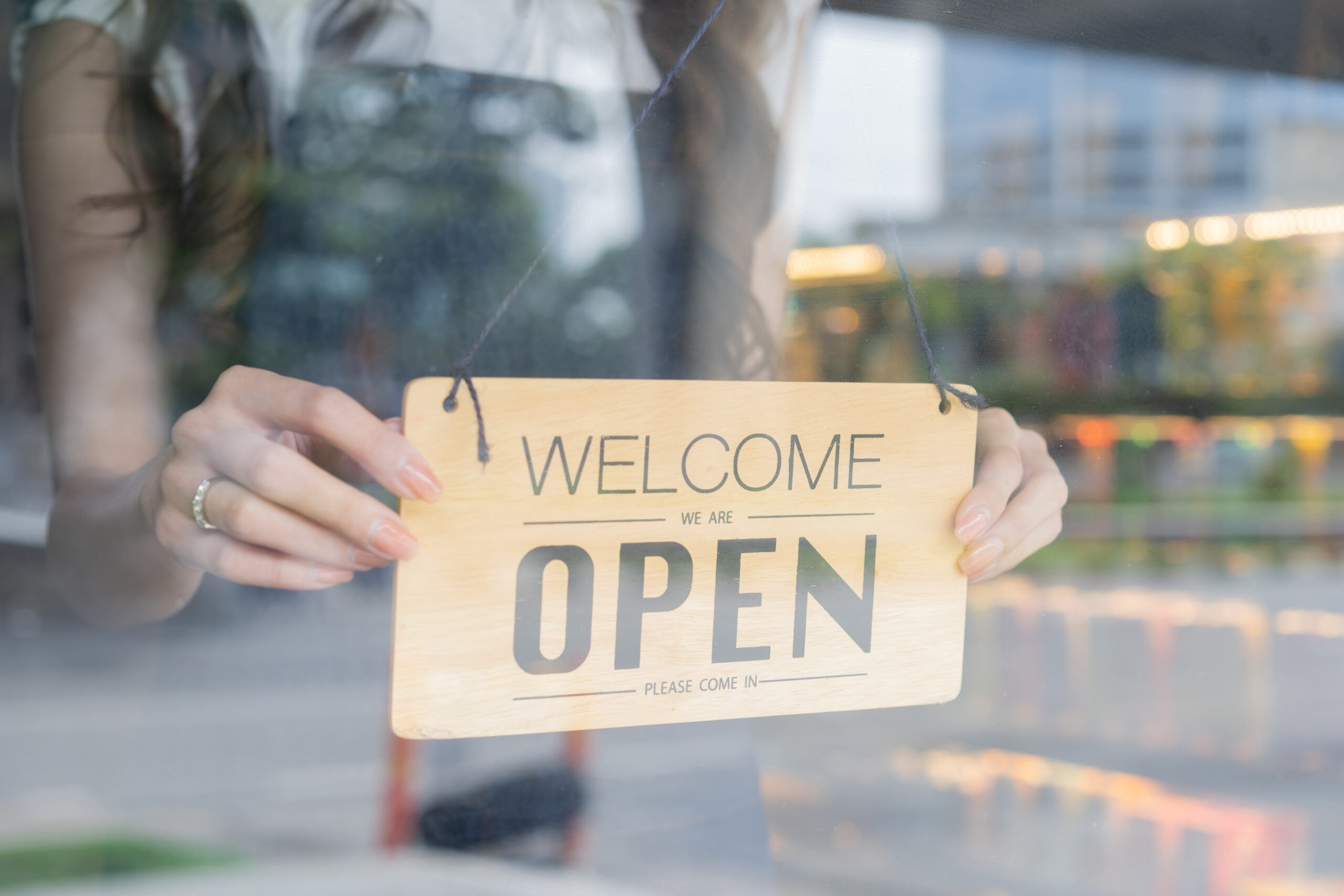Franklin and Williamson County store owner turning open sign.