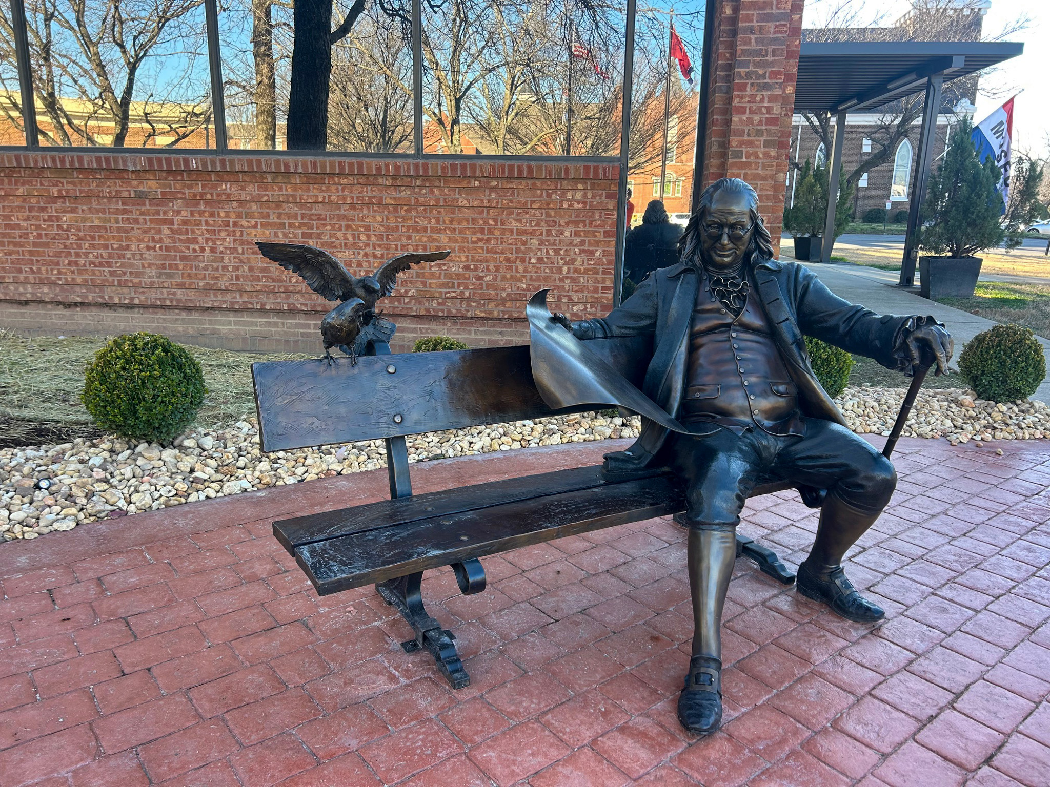 Ben on the Bench public art installation in downtown Franklin, Tennessee, featuring Benjamin Franklin seated beside a bronze eagle.