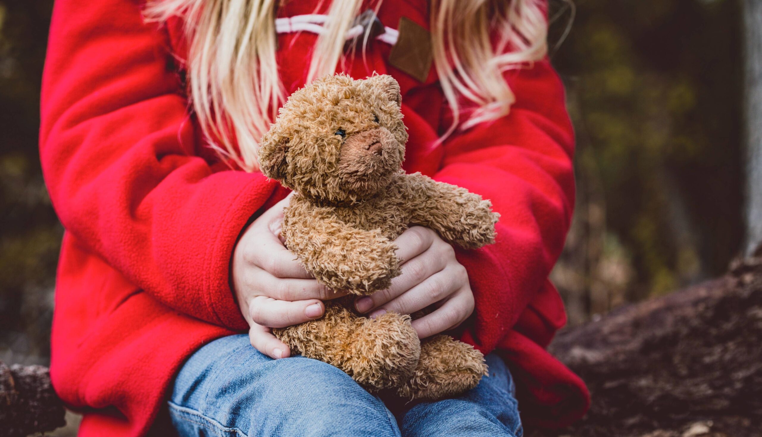 Child advocacy and protection organizations in Williamson County, TN, supporting children’s safety and emotional well-being, represented by a child holding a stuffed animal for comfort.