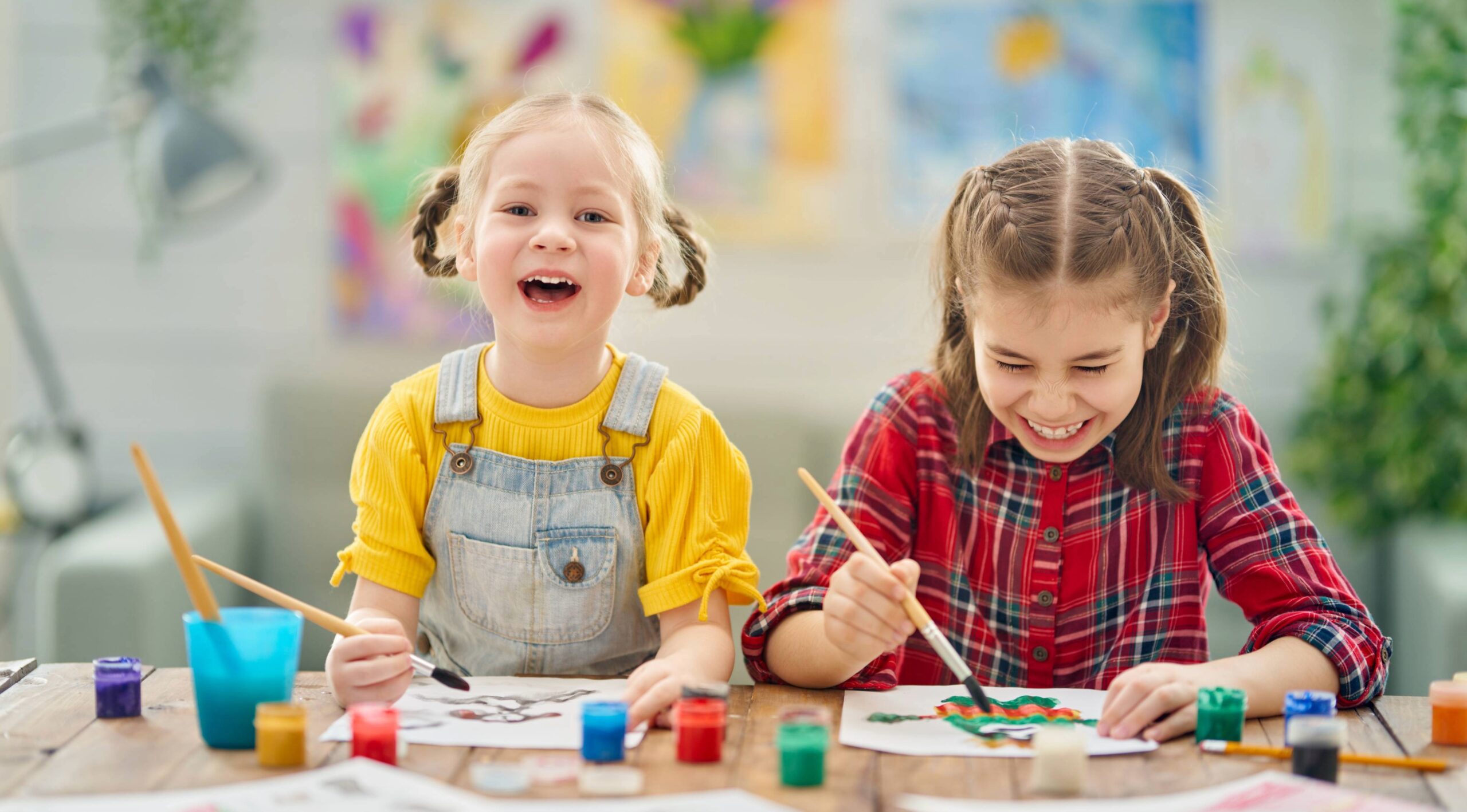 Hands on art and creative activities for kids in Franklin and Brentwood, TN, two young girls painting and smiling in an art studio.