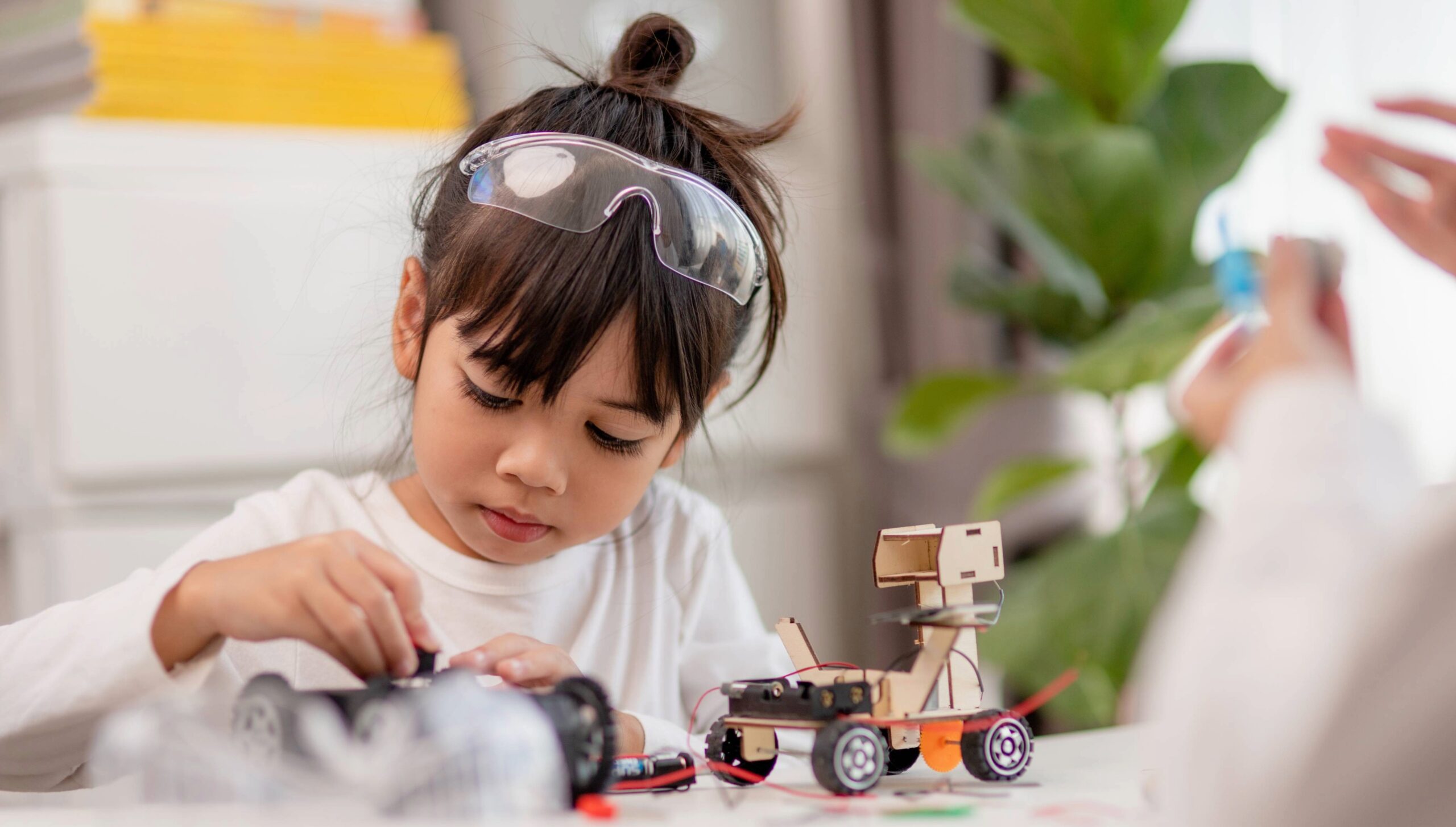STEM, robotics, and tech learning for kids in Franklin and Williamson County, TN, young child assembling a robotic vehicle