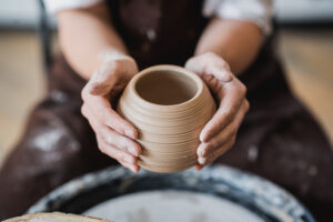 Throwing pottery on a ceramics wheel at Mud Puddle Pottery in Pegram, TN.