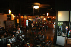 Crown Cigar and Ales, Brentwood, TN, men in the cigar lounge enjoying a cigar and a drink.