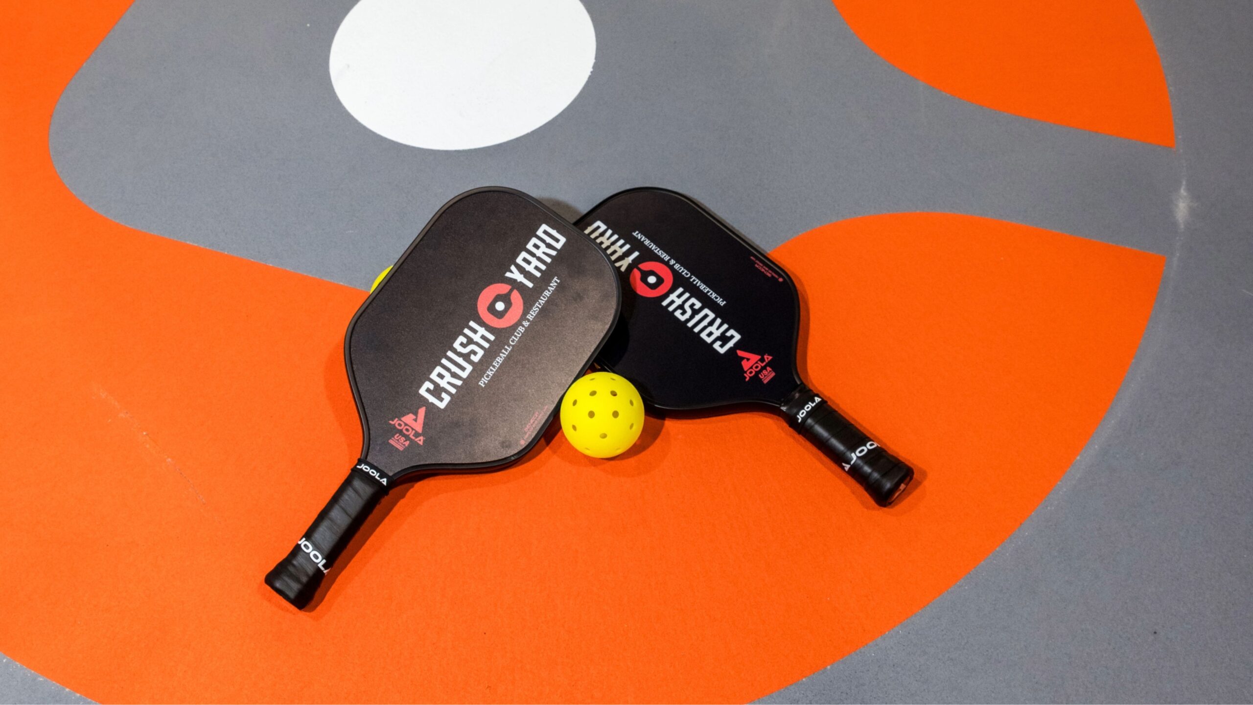 Crush Yard Nashville Grand Opening in Brentwood, Tennessee, showing pickleball paddles on the court.