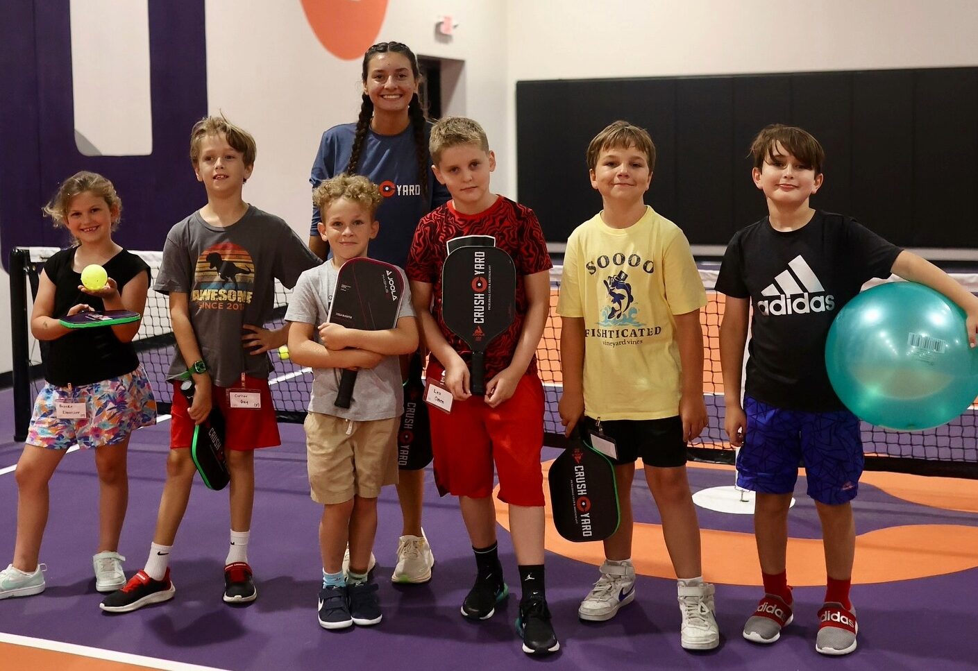 Crush Yard Nashville in Brentwood, TN, children holding pickleball paddles during a youth clinic at Crush Yard.