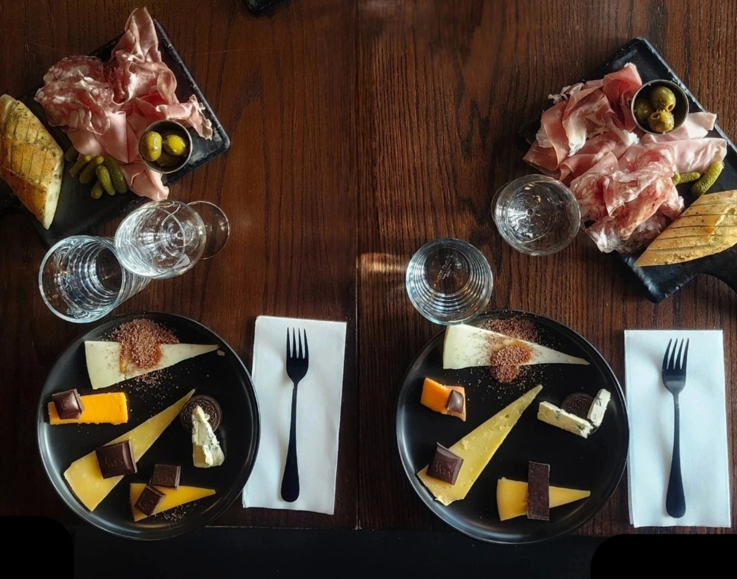 Valentine’s Day at The Factory at Franklin dining at Grey’s Fine Cheeses, showing a cheese and charcuterie spread with artisan cheeses, cured meats, chocolate pairings, and wine for a shared Valentine’s meal in Franklin, Tennessee.