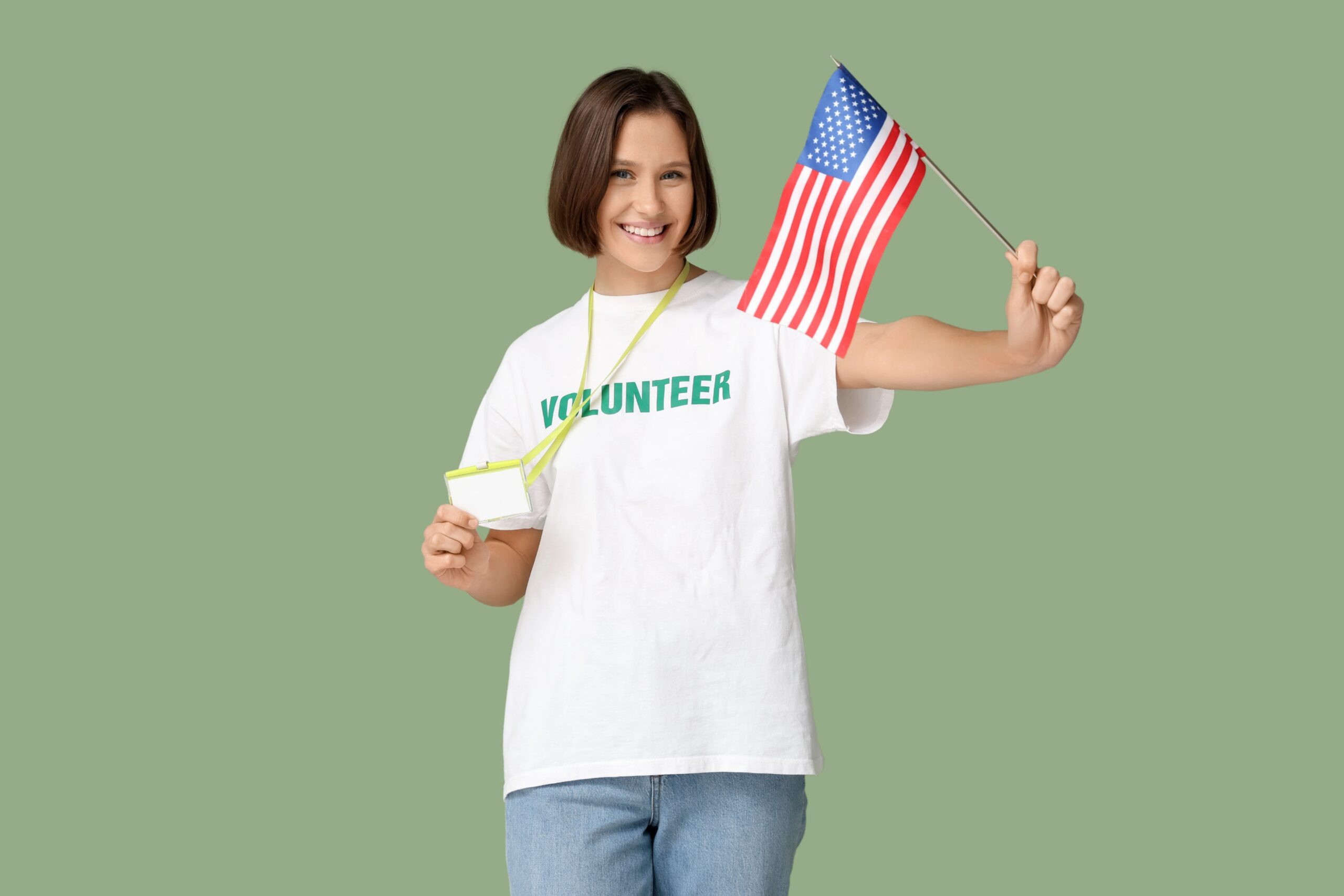 America 250 Volunteer, showing woman in volunteer shirt holding an American flag.