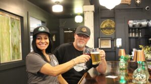 Black Dog Pub Music Lounge in Franklin, TN, owners Marc and Peggy Driskill seated at bar with drinks