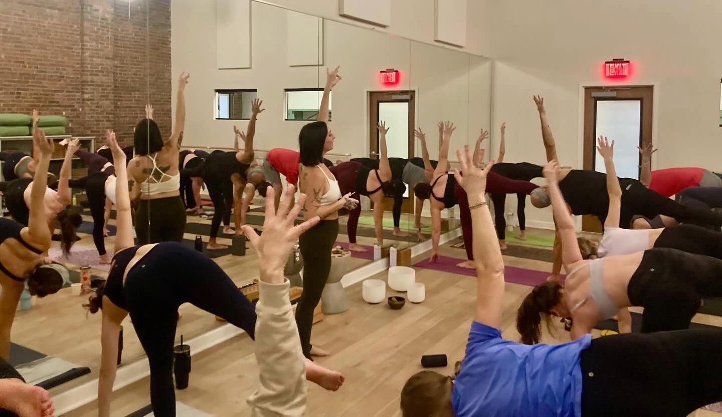 Ground Floor Yoga at The Factory at Franklin, showing a yoga studio with practioneers.