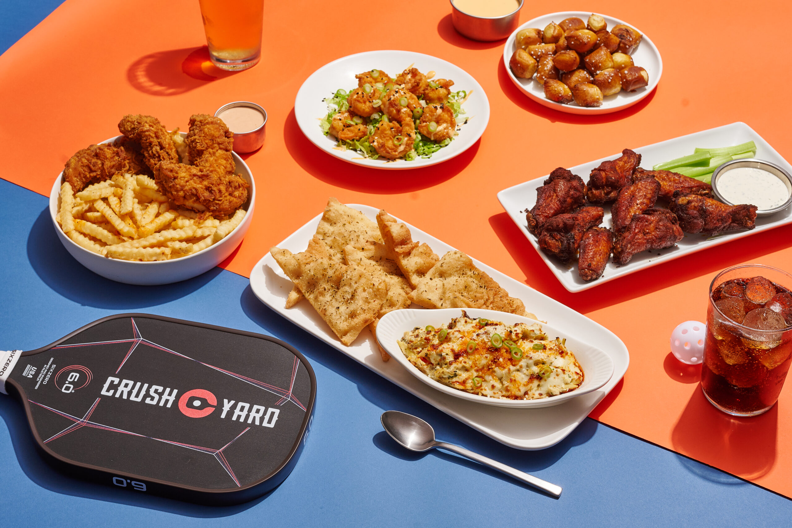 Crush Yard Nashville in Brentwood, TN. pickleball for all ages, food and drink, appetizers, lunch, and dinner, plated dishes and pickleball paddle view.