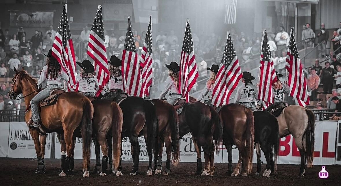 Franklin Rodeo riders carrying American flags during opening ceremony in Williamson County, Tennessee