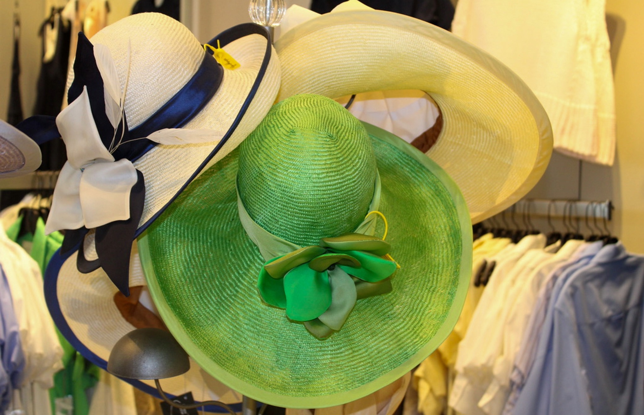 Green and white wide-brim hats by Christine Moore on display at Gus Mayer in Nashville for Iroquois Steeplechase fashion