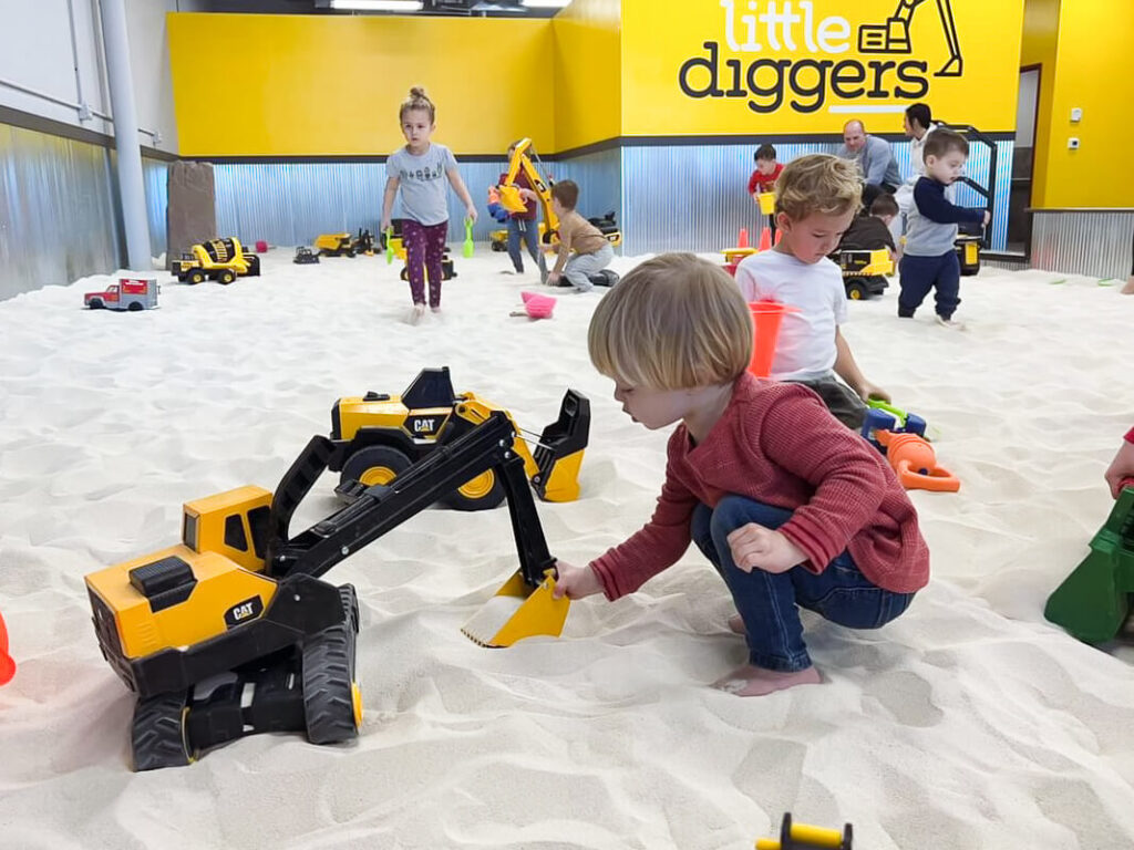Little Diggers Franklin, TN, child plays in sandbox with CAT toy truck