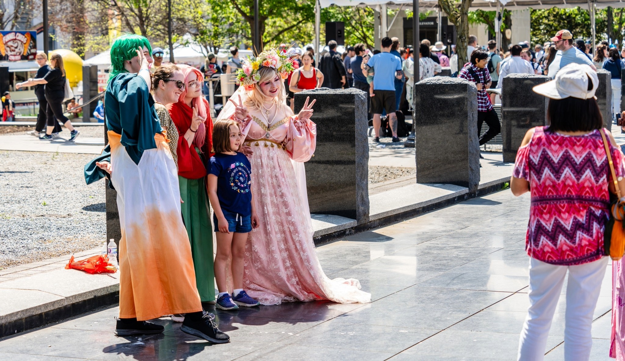 Festival attendees in cosplay posing for photos at the Nashville Cherry Blossom Festival in downtown Nashville.